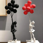 Statue de fille avec ballons